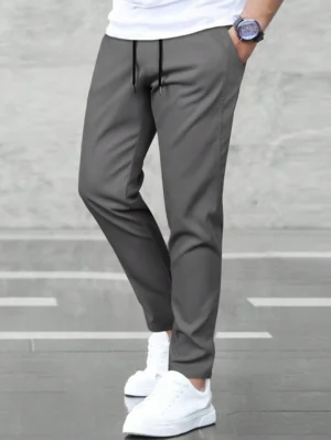 Pantalon uni à poches obliques et cordon de serrage à la taille pour homme